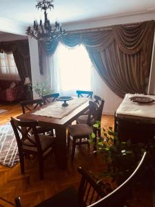 a dining room with a table and chairs and a window at Be my guest Apt/kafr abdo in Alexandria