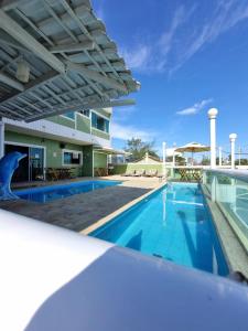 a view of the pool at a resort with a swimming pool at Hotel Aconchego Da Vila in Saquarema