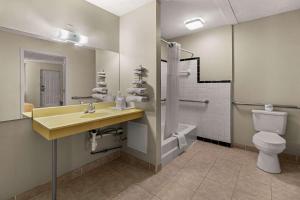 a bathroom with a sink and a toilet at Rodeway Inn in Dickson