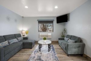 a living room with two couches and a table at Quality Inn in Oneida