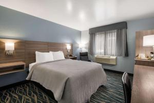 a hotel room with a large bed and a window at Quality Inn in Oneida