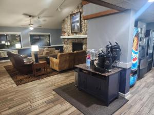 a living room with a couch and a fireplace at AmericInn by Wyndham Austin in Austin