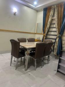 a dining room with a wooden table and chairs at Prime PH Home in Port Harcourt
