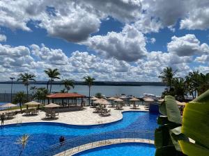a view of the pool at a resort at Luxurious Flat at Lake Side with lake view. in Brasília