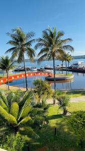 a river with palm trees and a boat in the water at Luxurious Flat at Lake Side with lake view. in Brasília