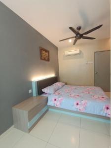 a bedroom with a bed and a ceiling fan at AYRA HOMESTAY in Kuala Kangsar