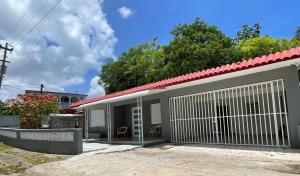 a house with a garage with a red roof at Casa Luquillo in Fajardo