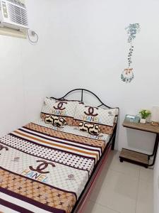 a bed in a room with two pillows on it at Honeydew Transient House in Mabiga