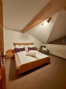 a bedroom with a large bed in a attic at Ferienwohnung Vesna & Alex in Elmen