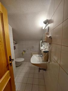 a small bathroom with a sink and a toilet at Ferienwohnung Vesna & Alex in Elmen
