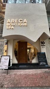 a store front of a building with a sign on it at Areca Boutique Apartments Hanoi in Hanoi