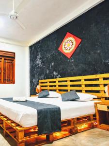 a bedroom with two beds and a red flag on the wall at Inside Out Nature Villa in Kandy