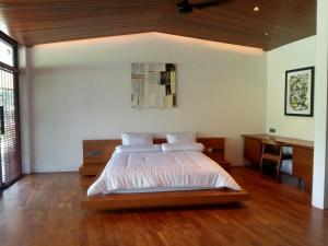 a bedroom with a bed and a desk at Beautiful Round Villa in Payangan in Payangan