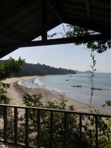a view of a beach from a balcony at The Big House in Koh Chang Ranong