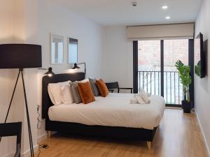 a bedroom with a bed and a large window at Stay U-nique Apartments Albeniz BCN in Hospitalet de Llobregat
