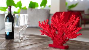 a bottle of wine and two wine glasses on a table at Boutique Hotel Las Flores Punta Cana in Punta Cana