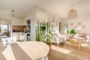 a living room with a table and a kitchen at Résidor - Beautiful appartment 2P in Paris