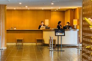 three women sitting at a counter in a hotel lobby at The Prince Hakone Lake Ashinoko in Hakone