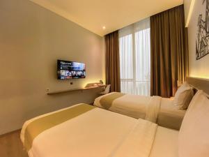 TV i/ili multimedijalni sistem u objektu Facade Hotel by Azana