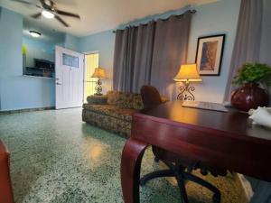 a living room with a table and a couch at Casa Laguna Unit 6, Spacious 3BR Near Beach and Restuarants in San Juan