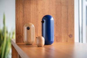 a table with a blue vase and two wooden figurines at voco Vienna Prater, an IHG Hotel in Vienna