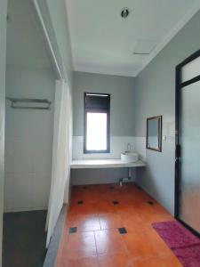 a bathroom with a sink and a window at Degung Hillside in Bogor