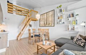 a living room with a couch and a table at Stunning Apartment In Ringkøbing in Ringkøbing