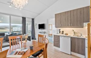 a kitchen and dining room with a table and a kitchen and a couch at Stunning Apartment In Ringkøbing in Ringkøbing