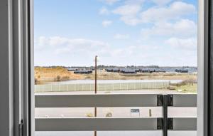 a window with a view of a tennis court at Stunning Apartment In Ringkøbing in Ringkøbing +13 photos