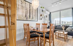 a dining room and living room with a table and chairs at Stunning Apartment In Ringkøbing in Ringkøbing
