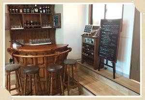 a bar with stools and a sign in a room at Mt.Fuji Rising Sun Inn in Fuji