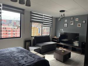 1 dormitorio con cama, sofá y TV en Apartamento céntrico y panorámico en La Paz, en La Paz