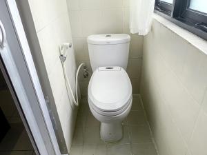 a bathroom with a white toilet in a stall at Beranda Plus near Hayam Wuruk 2 in Jakarta