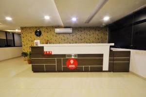 an empty lobby with a counter in a building at OYO Home Hotel Skyland in Ahmedabad