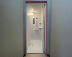 a walk in shower in a bathroom with a mirror at LivingAnywhere Commonsうるま Female Dormitory bunk bed - Vacation STAY 15503v in Uruma +5 photos