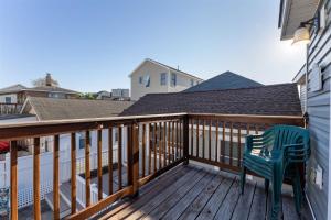 a green chair sitting on a wooden deck at 232 W Pine Ave 2 Beds, 1 Bath in Wildwood