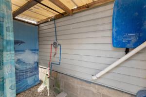 a wall of a building with a water hose at 232 W Pine Ave 2 Beds, 1 Bath in Wildwood