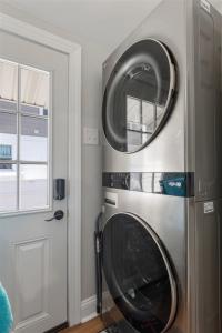 a washer and dryer in a kitchen next to a door at 232 W Pine Ave 4 Beds, 2 Baths in Wildwood