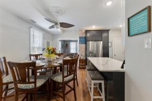 a kitchen and dining room with a table and chairs at 232 W Pine Ave 4 Beds, 2 Baths in Wildwood