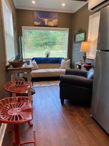 a living room with a couch and a window at Tiny House Oasis: Nature Escape in Nacogdoches