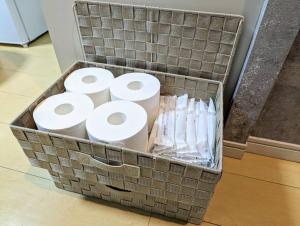 a basket full of toilet paper sitting on the floor at Home cruise西小山 in Tokyo