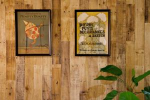 two framed posters on a wooden wall at AirHOME TOKYO EBISU 102 in Tokyo
