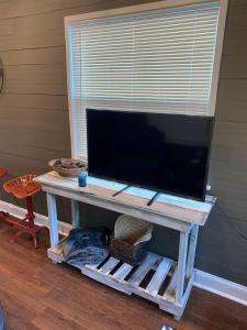 a tv sitting on top of a wooden table at Tiny House Oasis: Nature Escape in Nacogdoches