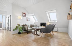 a living room with a table and a couch at Beautiful Apartment In Dalmose With Wi-fi 