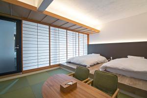 Rúm í herbergi á Forest Guardian Hotel 京都御所西