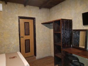 a bedroom with a bed and a book shelf and a desk at Hotel Rincon Huasteco in Ciudad Valles