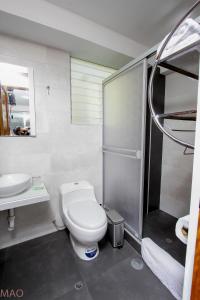 a bathroom with a toilet and a sink and a shower at Latinos House Cusco in Cusco