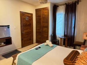 a bedroom with a bed with a towel on it at Suites Valentina in Puerto Morelos