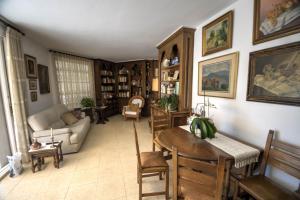 a living room with a couch and a table and chairs at Can Ferran by Hello Homes Sitges in Sitges