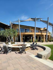 a building with chairs and a table and a fountain at Trilogy Polo Club - Casita in Indio